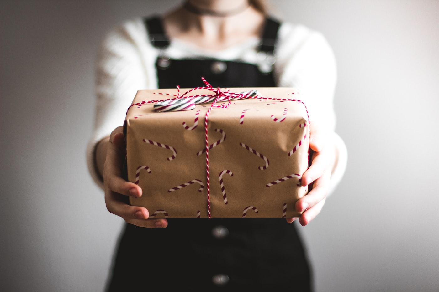 Kraft-paper gift boxes being wrapped with scissors and ribbon